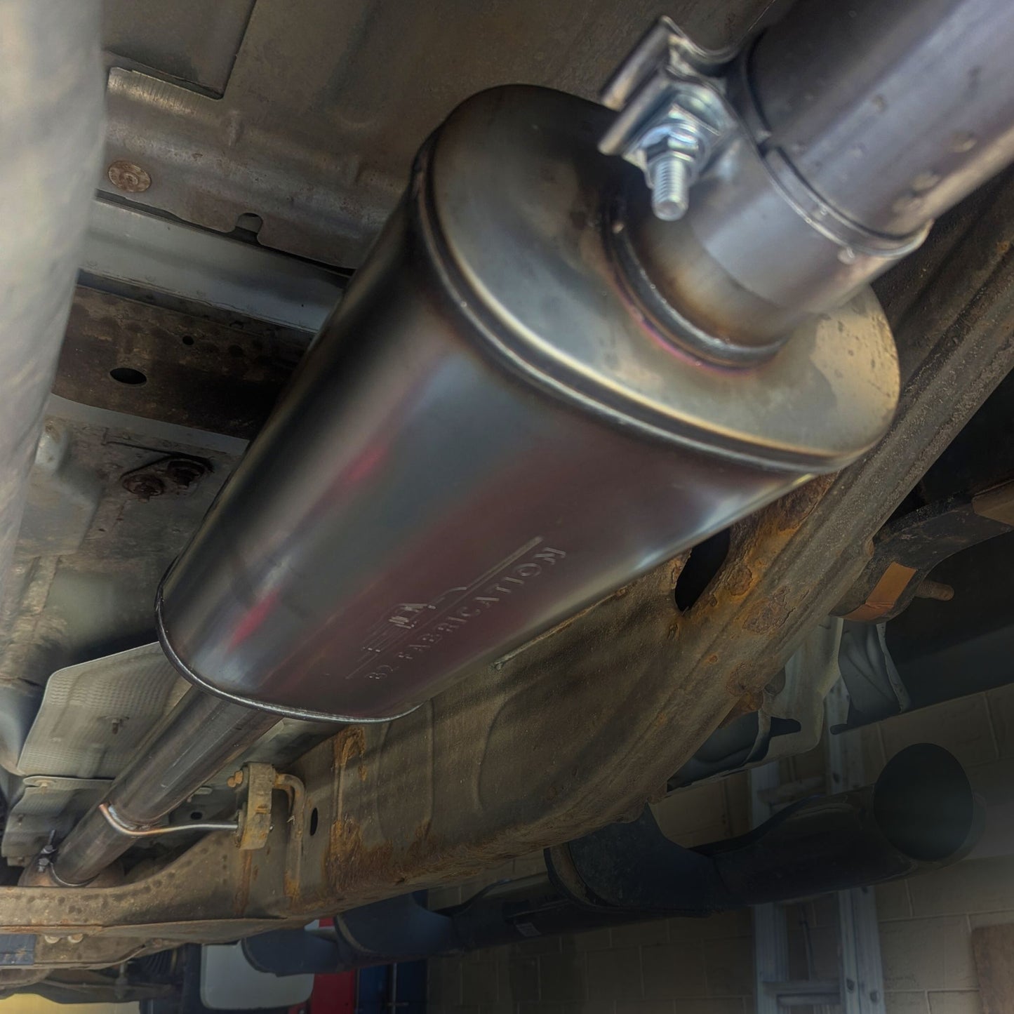 Close-up of a Silverado exhaust system with a focus on the muffler.