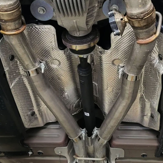 2015-2023 Dodge Challenger mid-muffler delete close-up showing 3-inch pipe